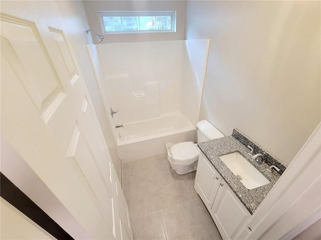 1049 East Hanover Road Graham, NC 27253 - Photo 12 of 14 a bathroom with a toilet and a shower