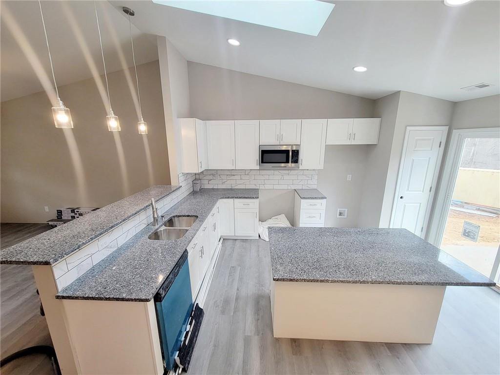 1049 East Hanover Road Graham, NC 27253 - Photo 2 of 14 a kitchen with granite countertop a sink a stove and a refrigerator