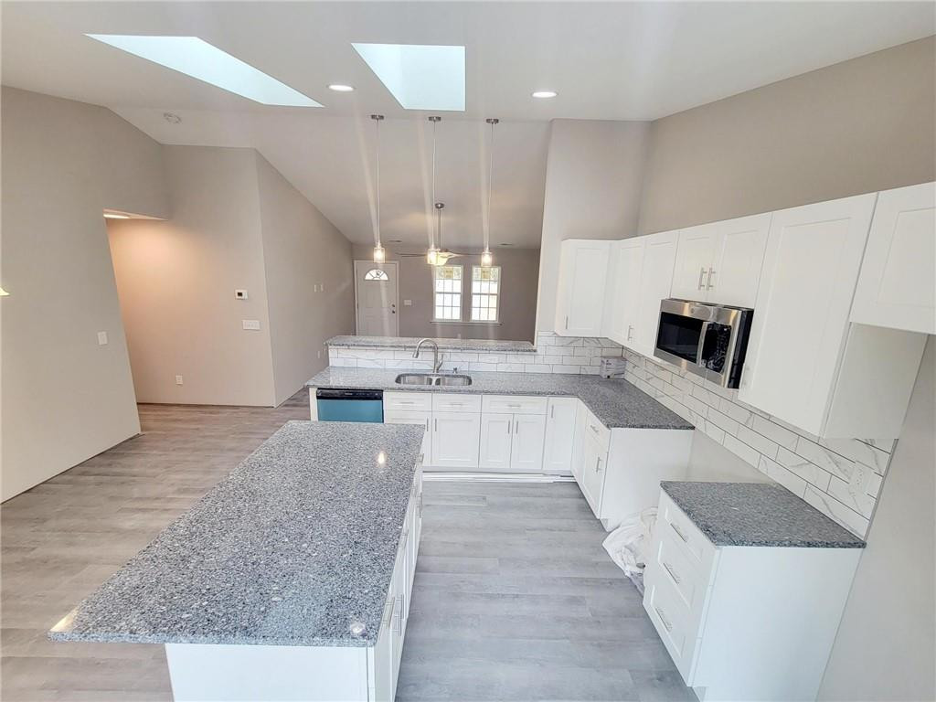 1049 East Hanover Road Graham, NC 27253 - Photo 3 of 14 a large white kitchen with stainless steel appliances kitchen island a large counter top a stove and a sink