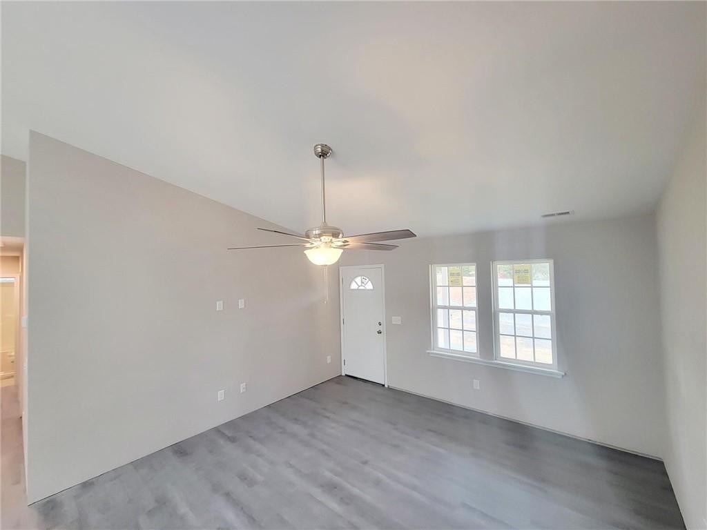1049 East Hanover Road Graham, NC 27253 - Photo 4 of 14 wooden floor in an empty room with a window