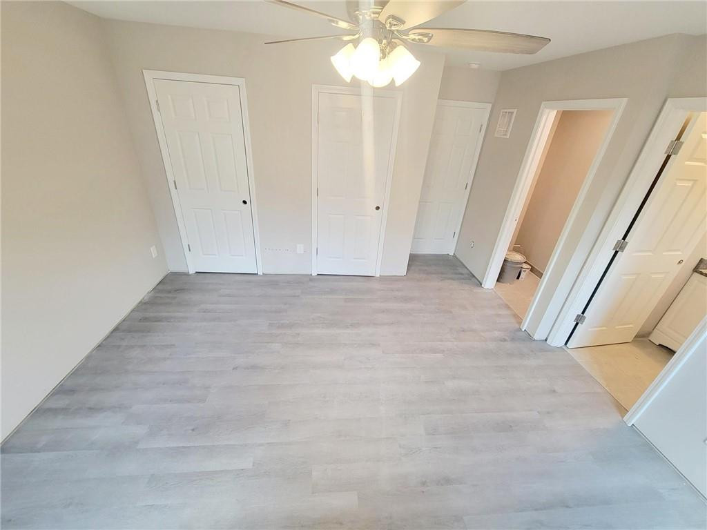 1049 East Hanover Road Graham, NC 27253 - Photo 7 of 14 a view of a hallway with a chandelier fan and wooden floor