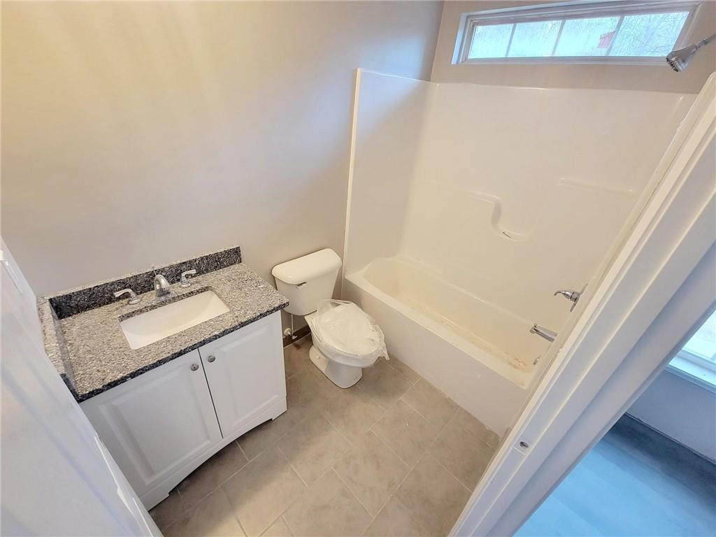1049 East Hanover Road Graham, NC 27253 - Photo 9 of 14 a bathroom with a granite countertop sink toilet and shower
