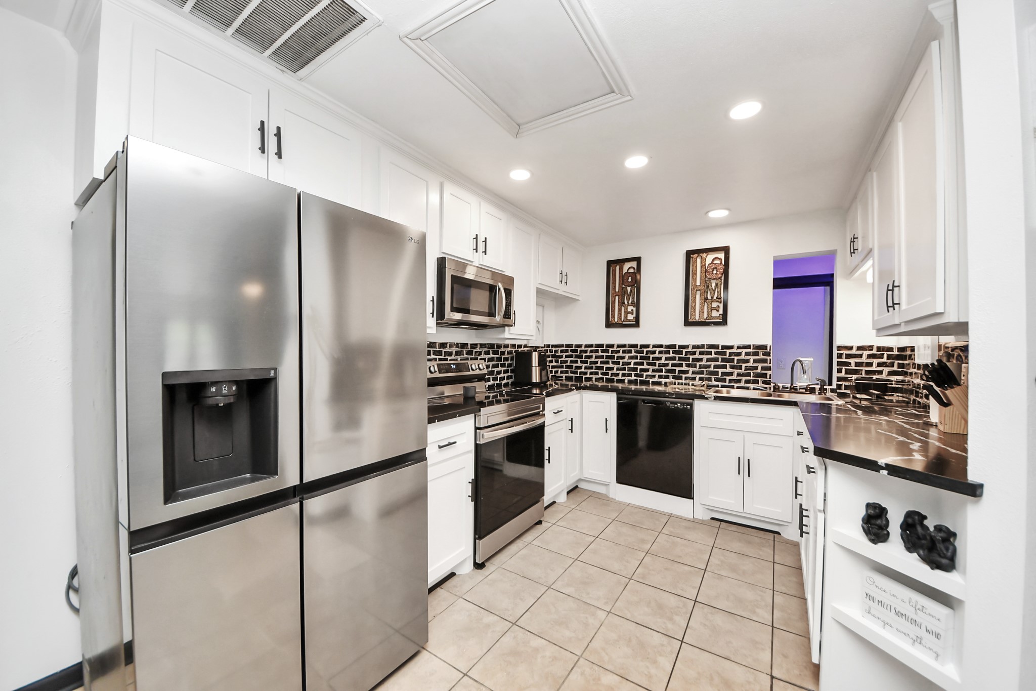 238 Waterfall Drive Huffman, TX 77336 - Photo 17 of 40 a kitchen with stainless steel appliances granite countertop a refrigerator and a sink
