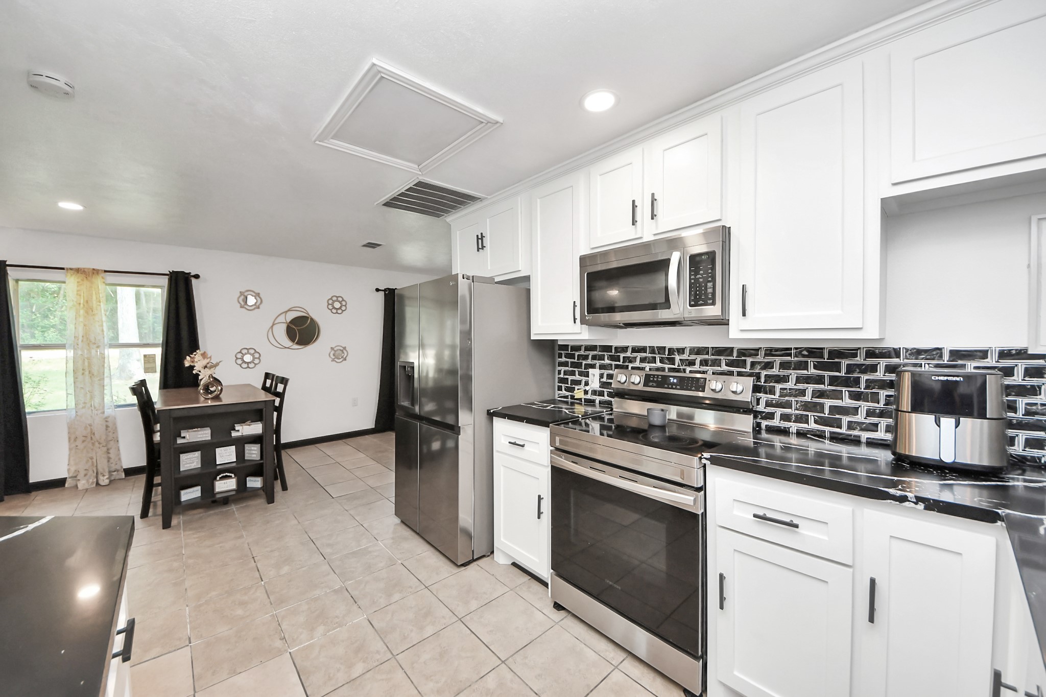 238 Waterfall Drive Huffman, TX 77336 - Photo 20 of 40 a kitchen with granite countertop a sink appliances and cabinets