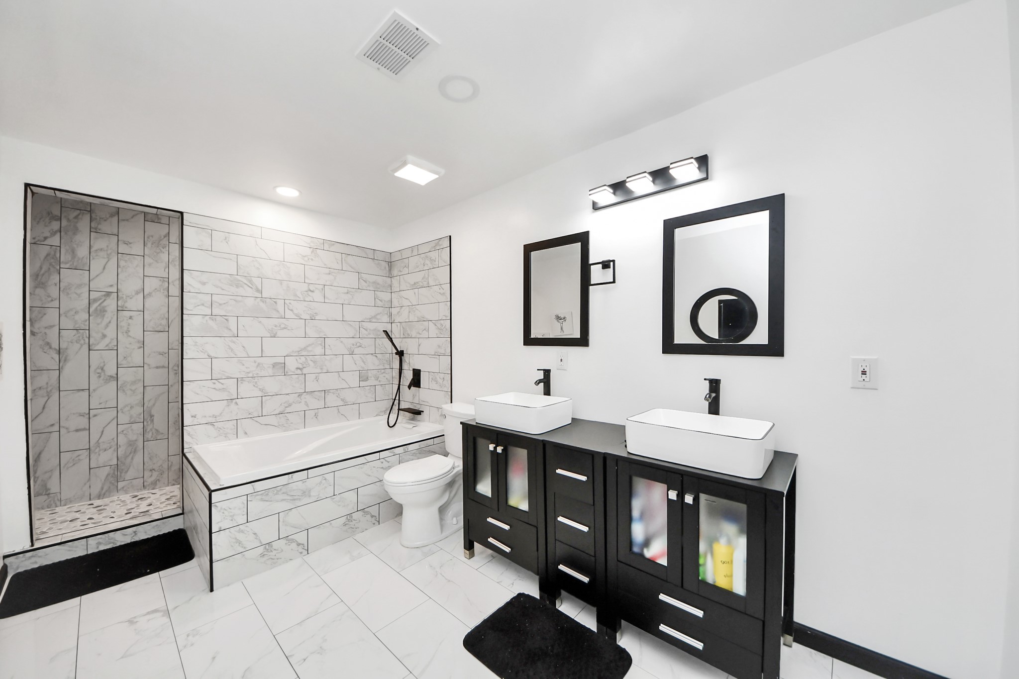 238 Waterfall Drive Huffman, TX 77336 - Photo 22 of 40 a bathroom with a double vanity sink a toilet a mirror and shower