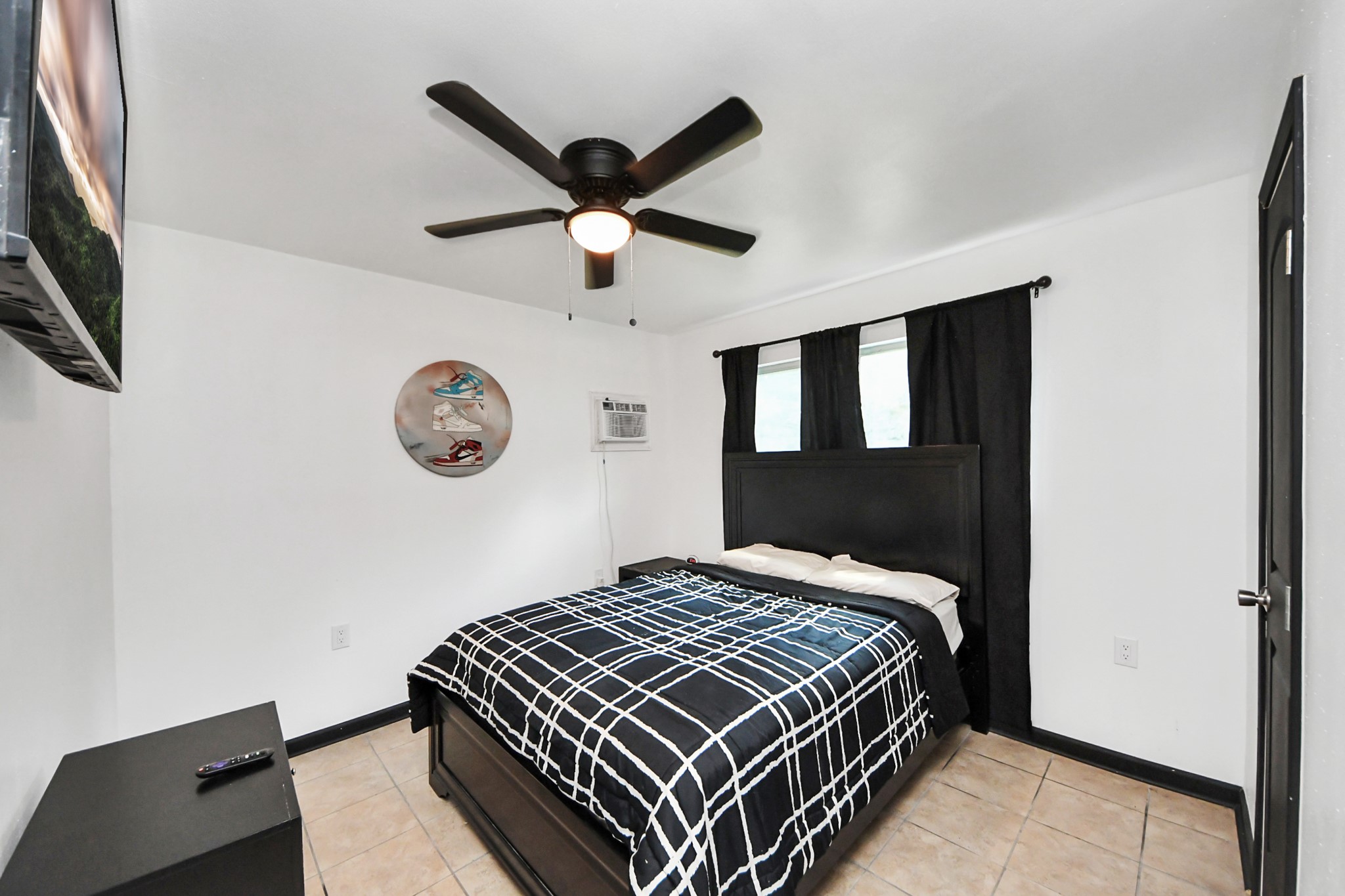 238 Waterfall Drive Huffman, TX 77336 - Photo 27 of 40 a bedroom with a large bed and a chandelier