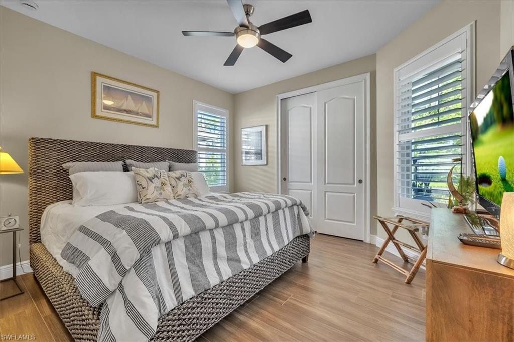 16424 Windsor Way Alva, FL 33920 - Photo 24 of 48 a spacious bedroom with a bed and a chandelier