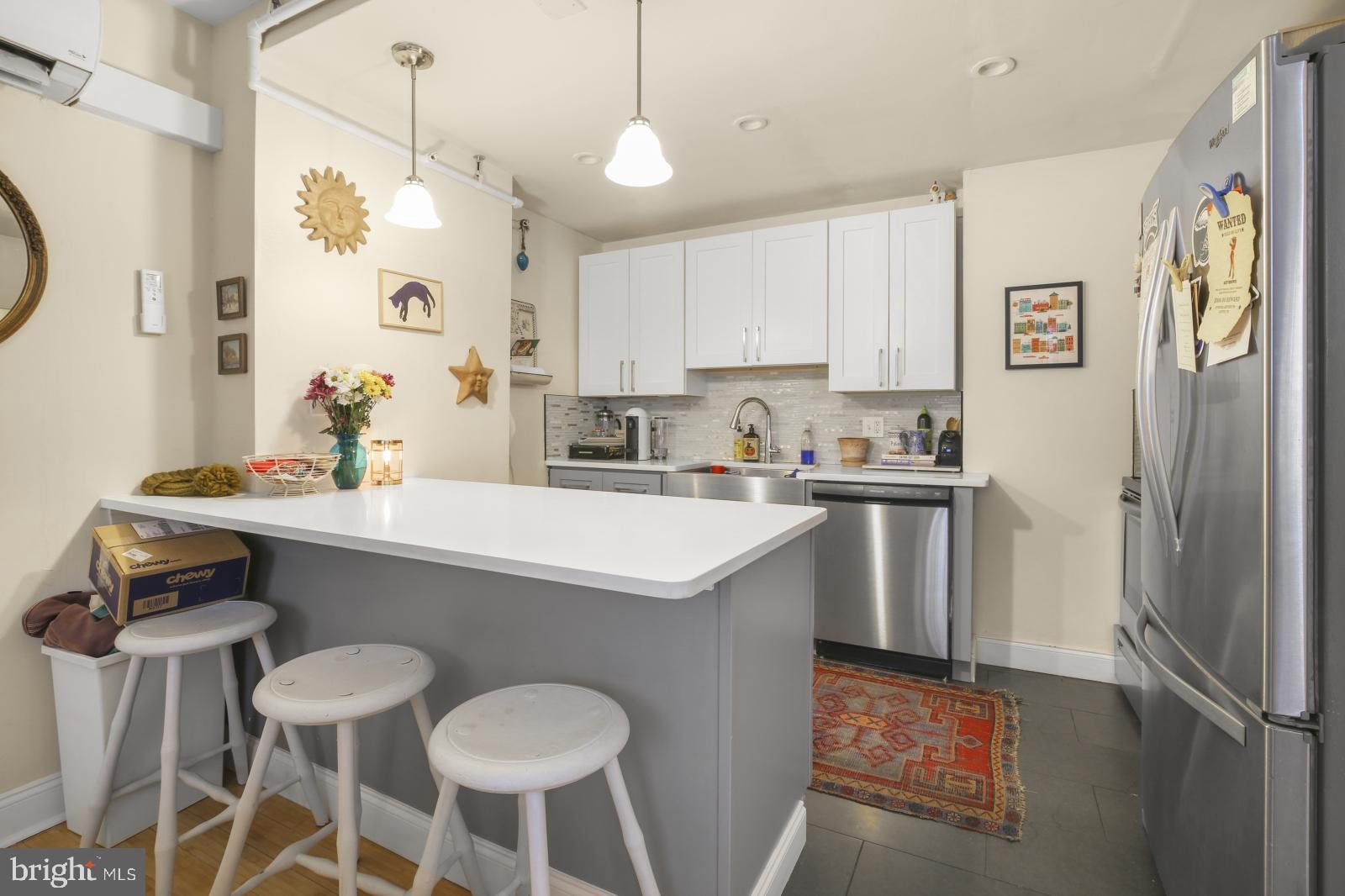 44 South 3rd Street, Unit 4R Philadelphia, PA 19106 - Photo 1 of 19 a kitchen with stainless steel appliances a sink a stove a refrigerator and cabinets