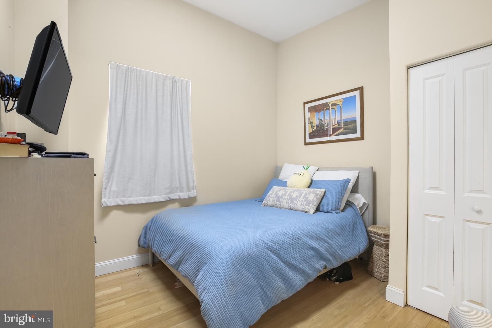 44 South 3rd Street, Unit 4R Philadelphia, PA 19106 - Photo 11 of 19 a bedroom with a bed and a flat screen tv
