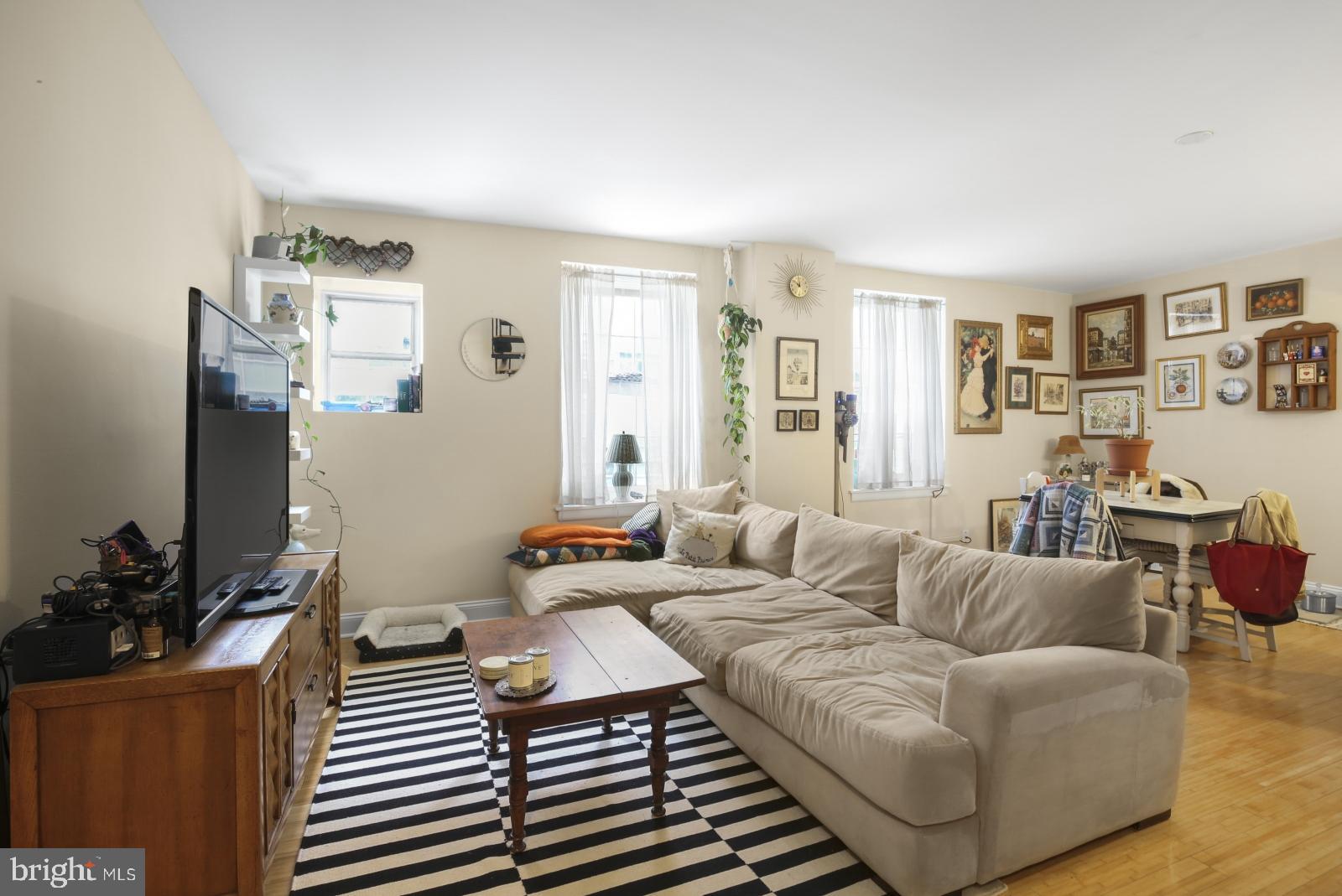 44 South 3rd Street, Unit 4R Philadelphia, PA 19106 - Photo 2 of 19 a living room with furniture a chandelier and a window