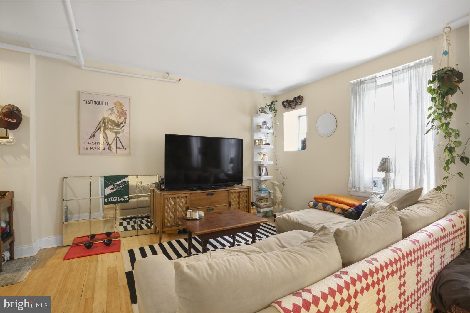 44 South 3rd Street, Unit 4R Philadelphia, PA 19106 - Photo 5 of 19 a living room with furniture and a flat screen tv