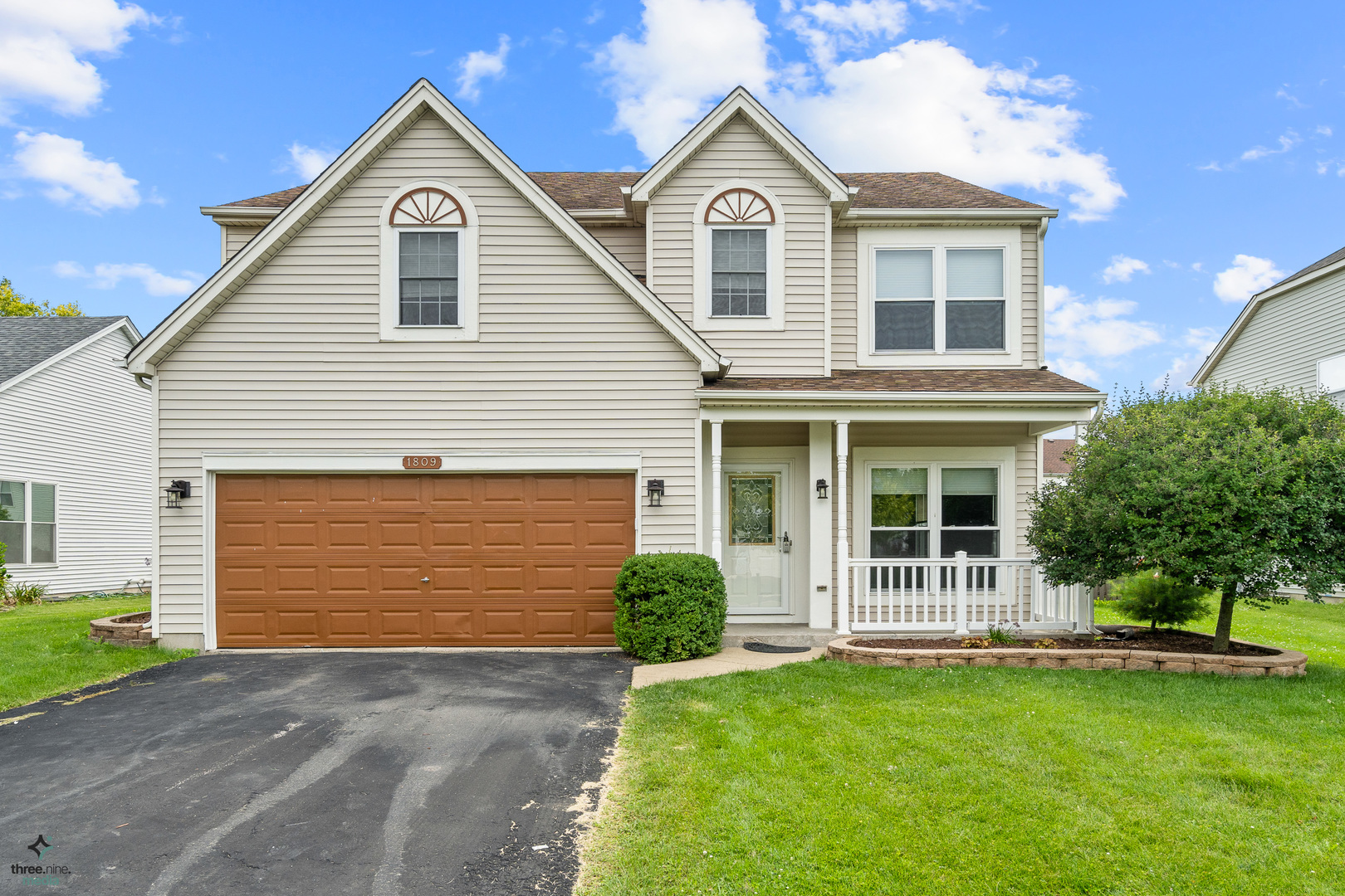 a front view of a house with a yard and garage