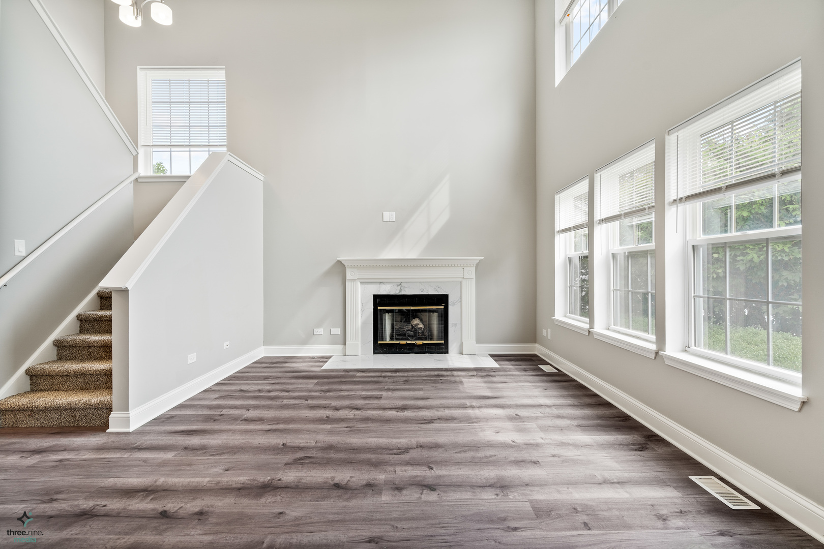 1809 Prairie Ridge Drive Plainfield, IL 60586 - Photo 13 of 32 a view of an empty room with wooden floor fireplace and a window