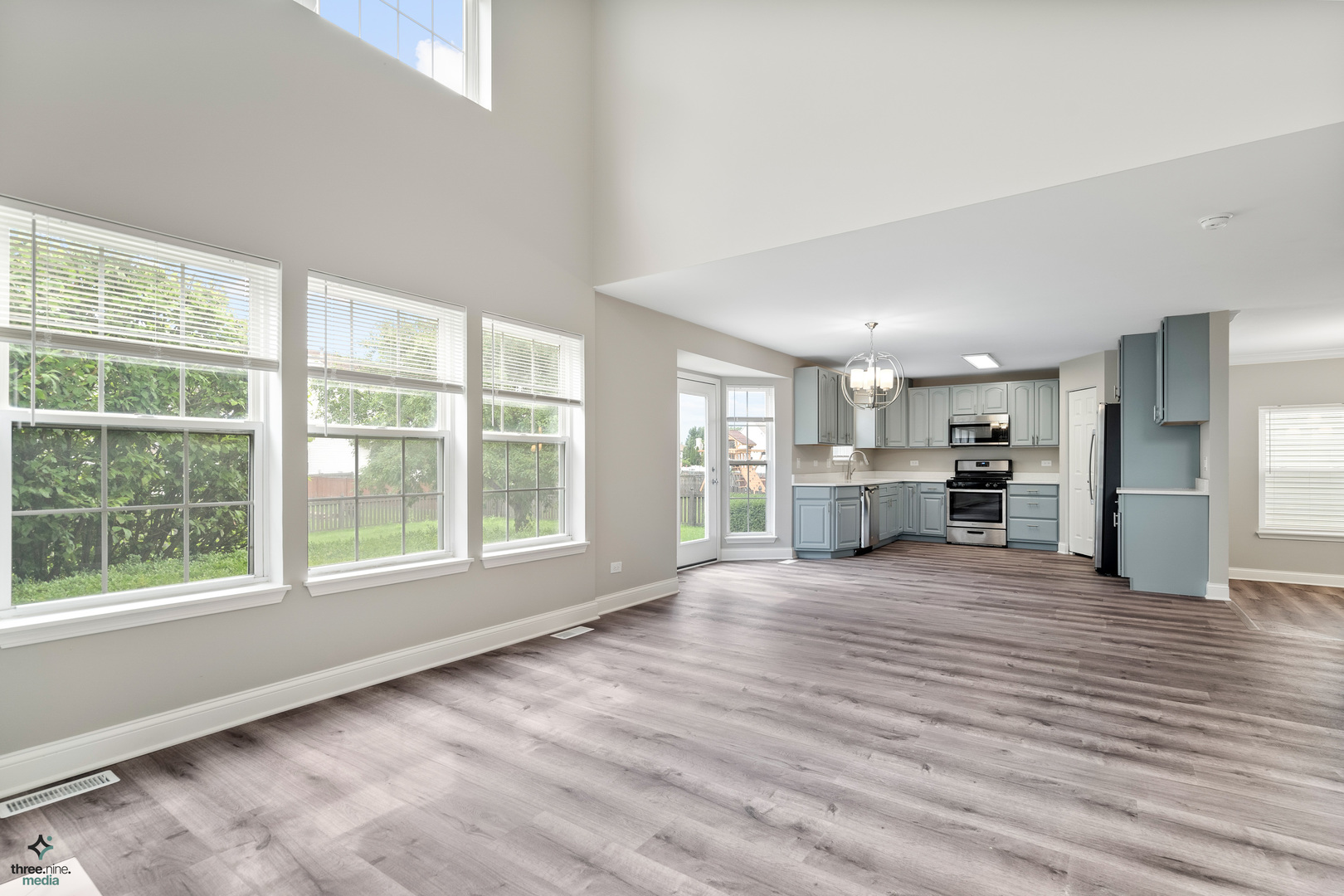 1809 Prairie Ridge Drive Plainfield, IL 60586 - Photo 14 of 32 a view of an empty room with a window and wooden floor