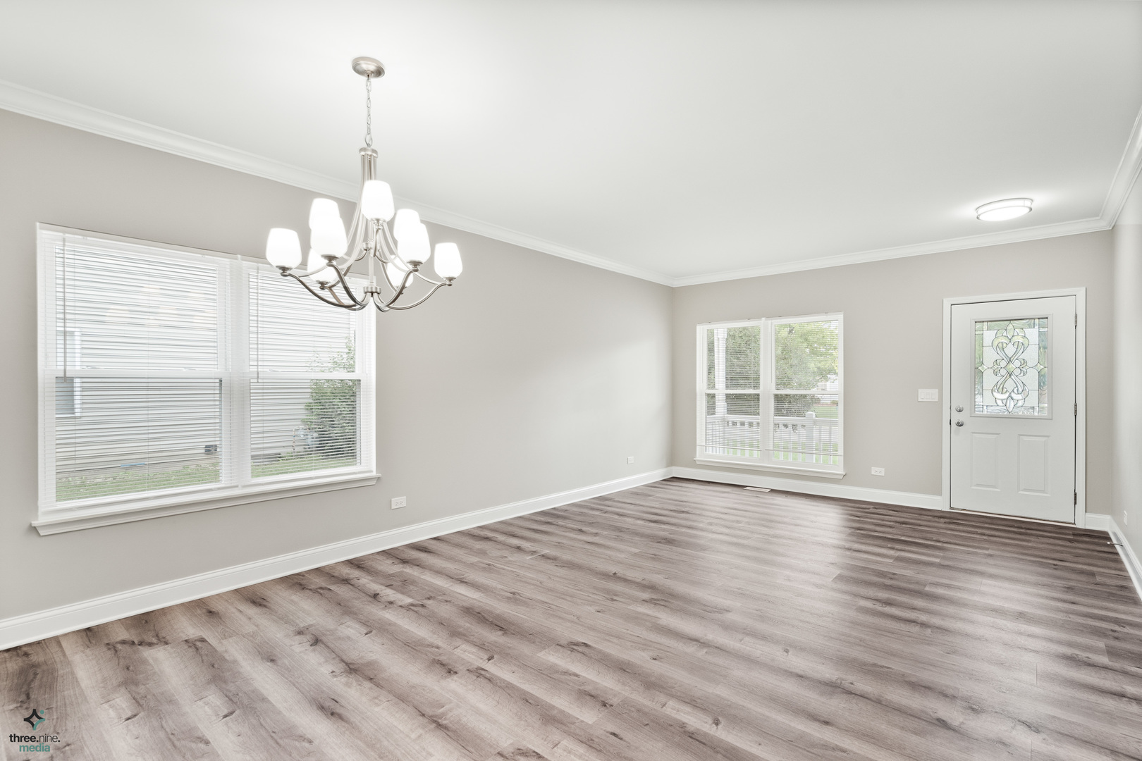 1809 Prairie Ridge Drive Plainfield, IL 60586 - Photo 3 of 32 a view of an empty room with wooden floor and a window