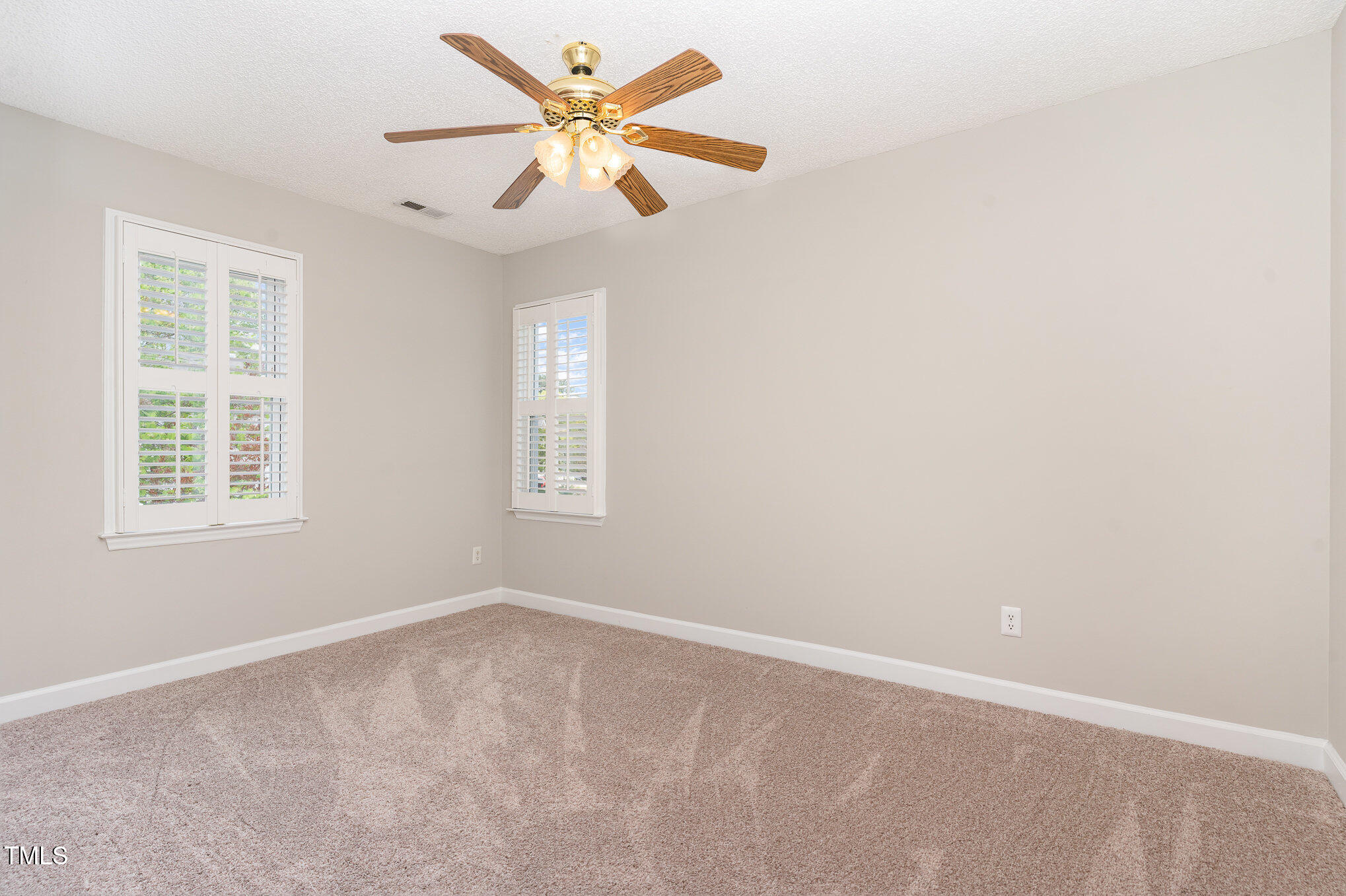 5033 Knightsbridge Way Raleigh, NC 27604 - Photo 15 of 40 an empty room with a window and a fan