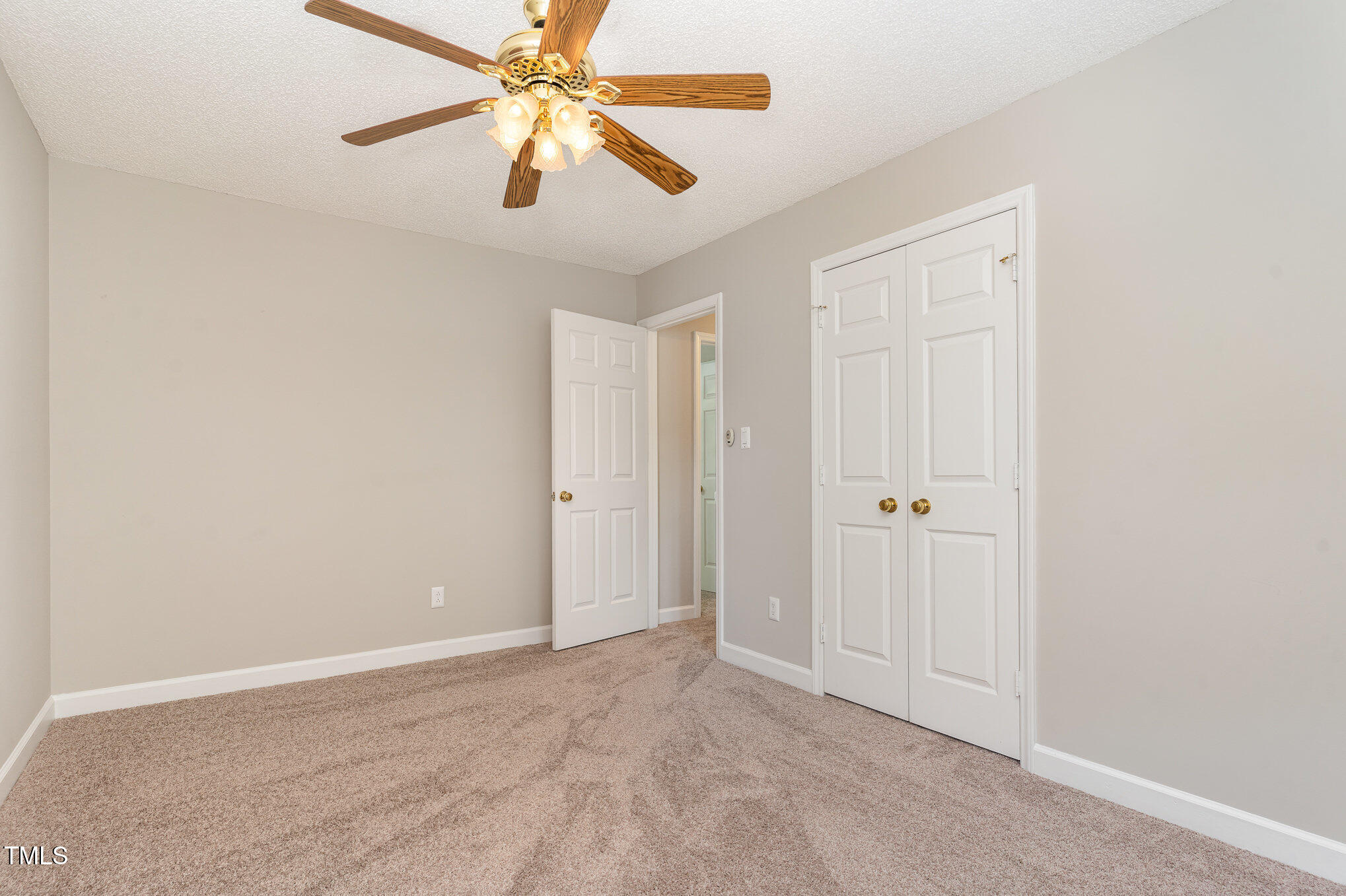 5033 Knightsbridge Way Raleigh, NC 27604 - Photo 16 of 40 an empty room with closet and a chandelier fan