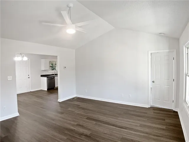 a view of a kitchen with wooden floor and a kitchen