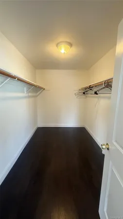 a view of a room with wooden floor and windows