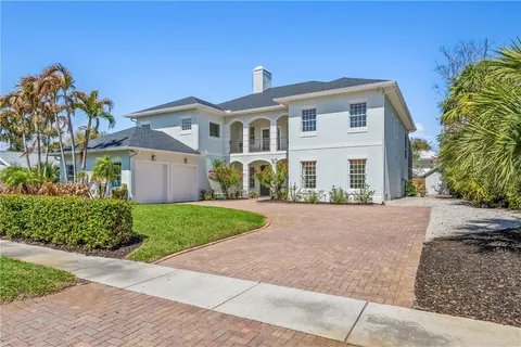 a front view of a house with a yard and a garage