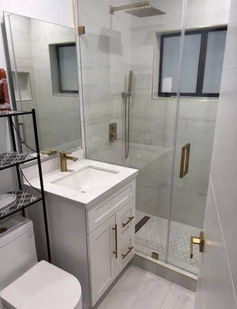 a bathroom with a sink a toilet and shower