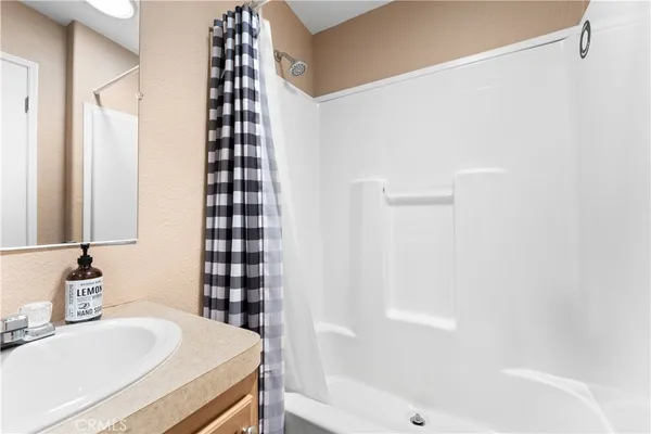a bathroom with a toilet a sink and a mirror