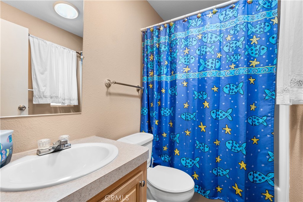 5900 Colorado River Road, Unit 18 Blythe, CA 92225 - Photo 25 of 58 a bathroom with a toilet a sink and a mirror