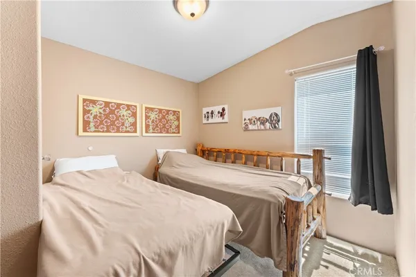 a bedroom with a bed and a book shelf