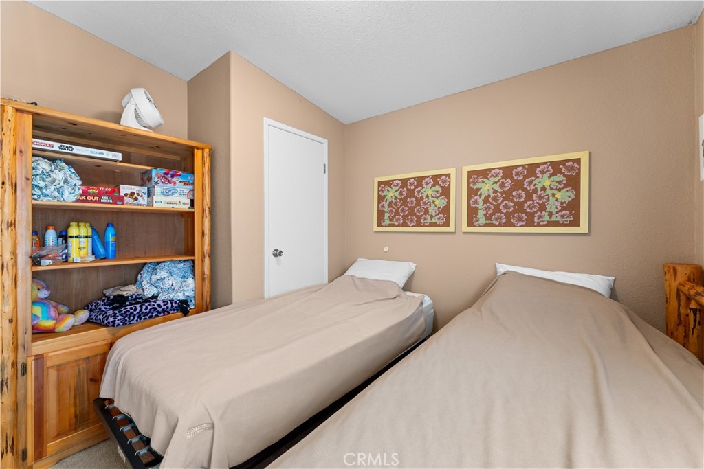 5900 Colorado River Road, Unit 18 Blythe, CA 92225 - Photo 27 of 58 a bedroom with a bed a wall painting and a shelf
