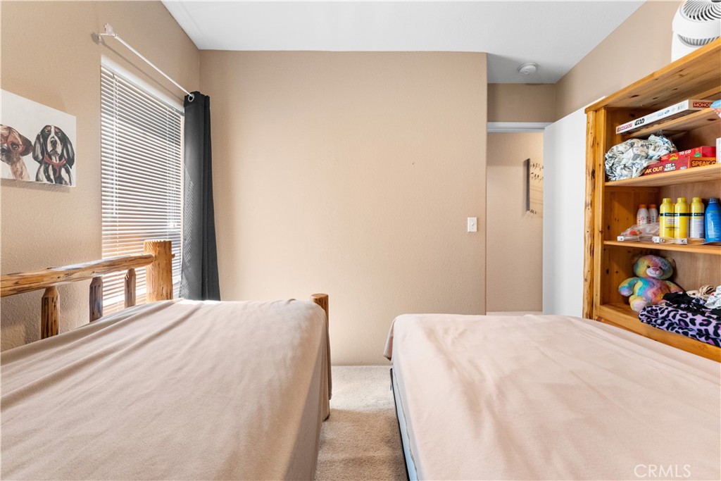 5900 Colorado River Road, Unit 18 Blythe, CA 92225 - Photo 28 of 58 a bedroom with a bed and a book shelf