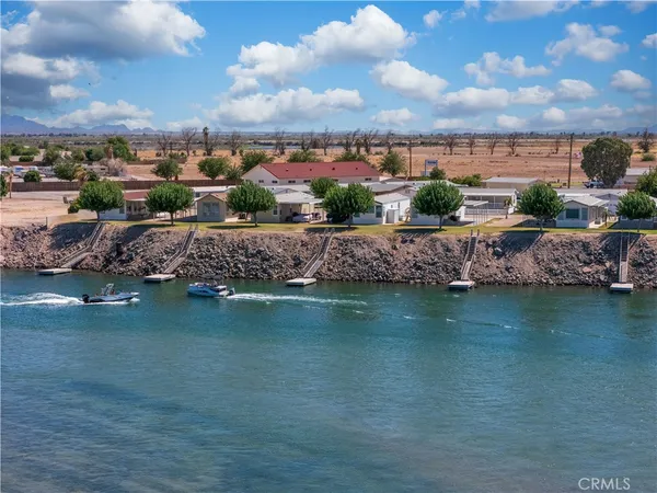 a view of a lake with houses in the back