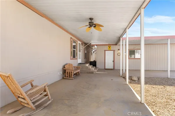 a view of a porch with a table and chairs