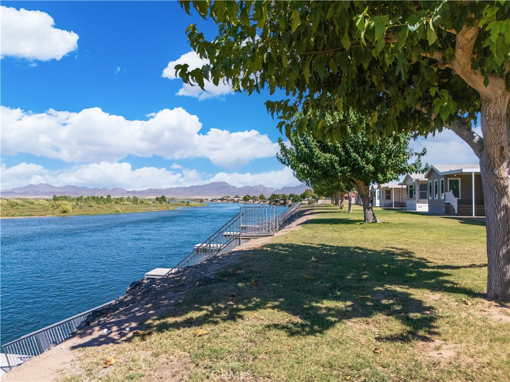 5900 Colorado River Road, Unit 18 Blythe, CA 92225 - Photo 56 of 58 a view of a lake with a house in the background