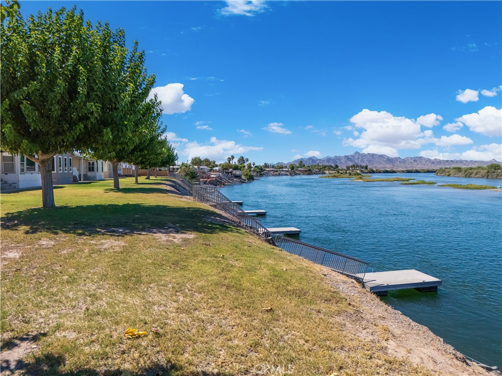 5900 Colorado River Road, Unit 18 Blythe, CA 92225 - Photo 57 of 58 a view of a lake with houses in the back