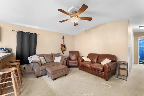 a view of a livingroom with workspace and a couch