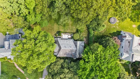 an aerial view of a house with a yard and garden