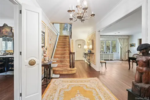 a view of a livingroom with furniture wooden floor and a chandelier