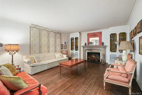 a living room with furniture a fireplace and a large window