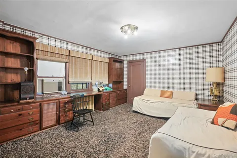 a work room with furniture and a flat screen tv