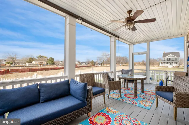 a view of a livingroom with wooden floor and stairs