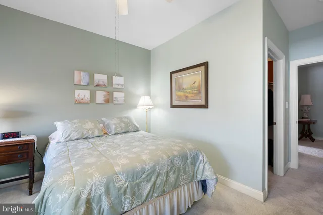 a living room with furniture a flat screen tv and a floor to ceiling window