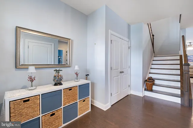 a kitchen with kitchen island granite countertop a sink cabinets and living room view