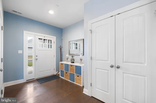 a kitchen with stainless steel appliances granite countertop a sink a stove and a wooden floor