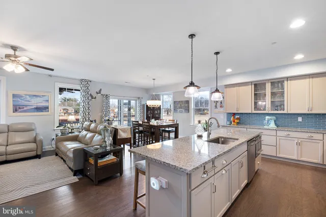a kitchen with white cabinets and appliances