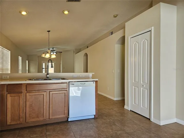 a view of a kitchen with a sink and chandelier