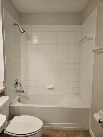 a bathroom with a toilet and a bath tub