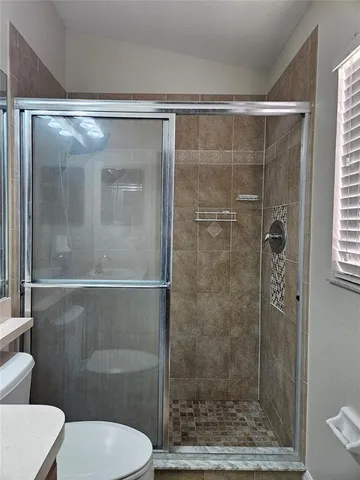 a bathroom with a shower and a toilet