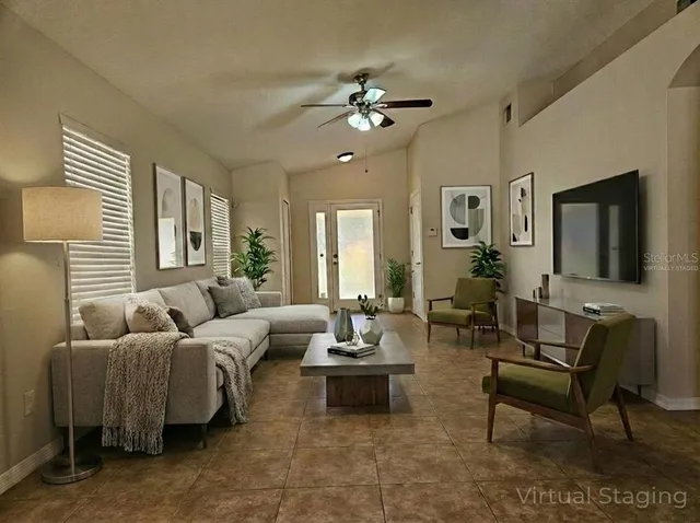 a living room with furniture and a large mirror