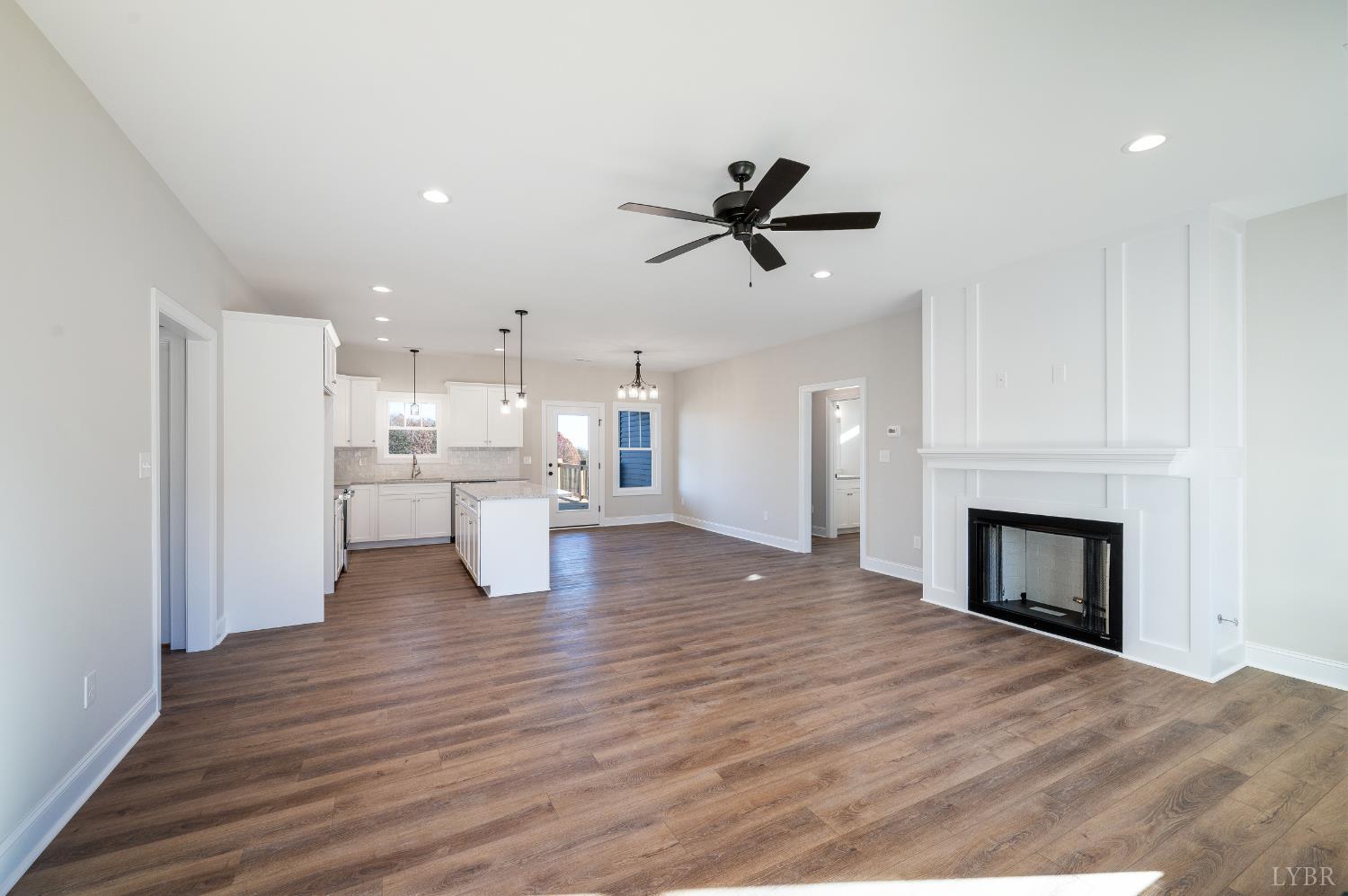 10402 Leesville Road Lynch Station, VA 24571 - Photo 2 of 45 a view of a living room a kitchen with a fireplace and wooden floor