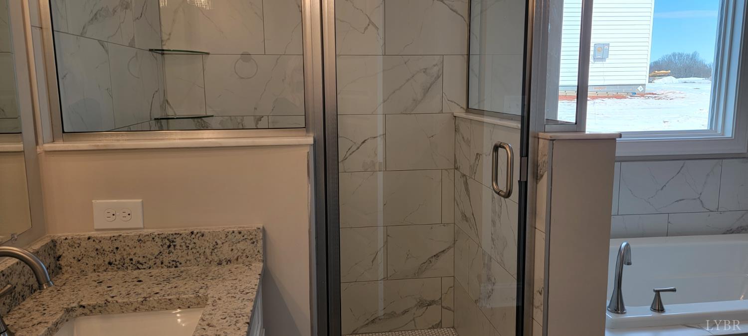 10402 Leesville Road Lynch Station, VA 24571 - Photo 30 of 45 a bathroom with a granite countertop window and a shower